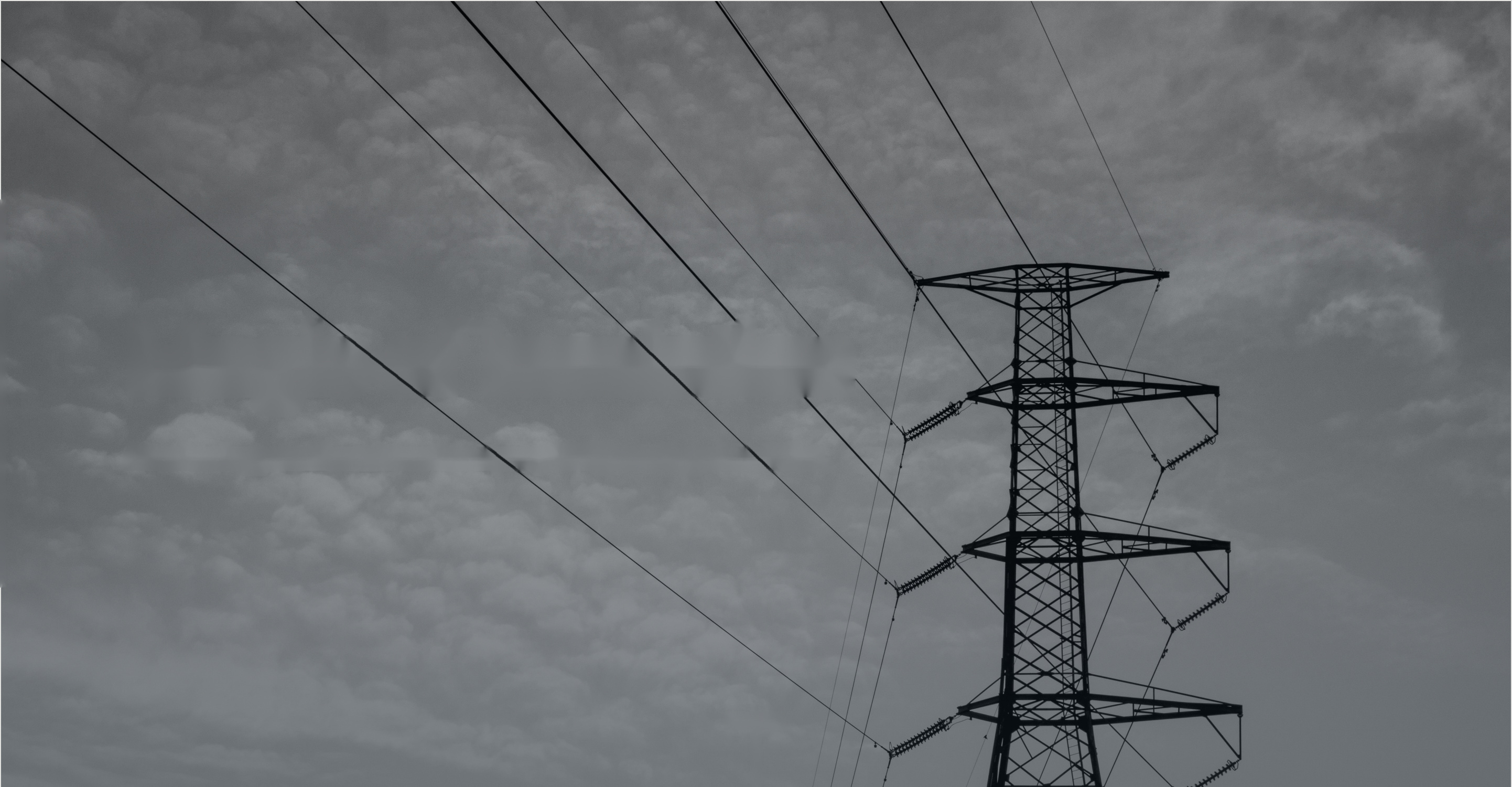 High-voltage transmission line against an overcast sky